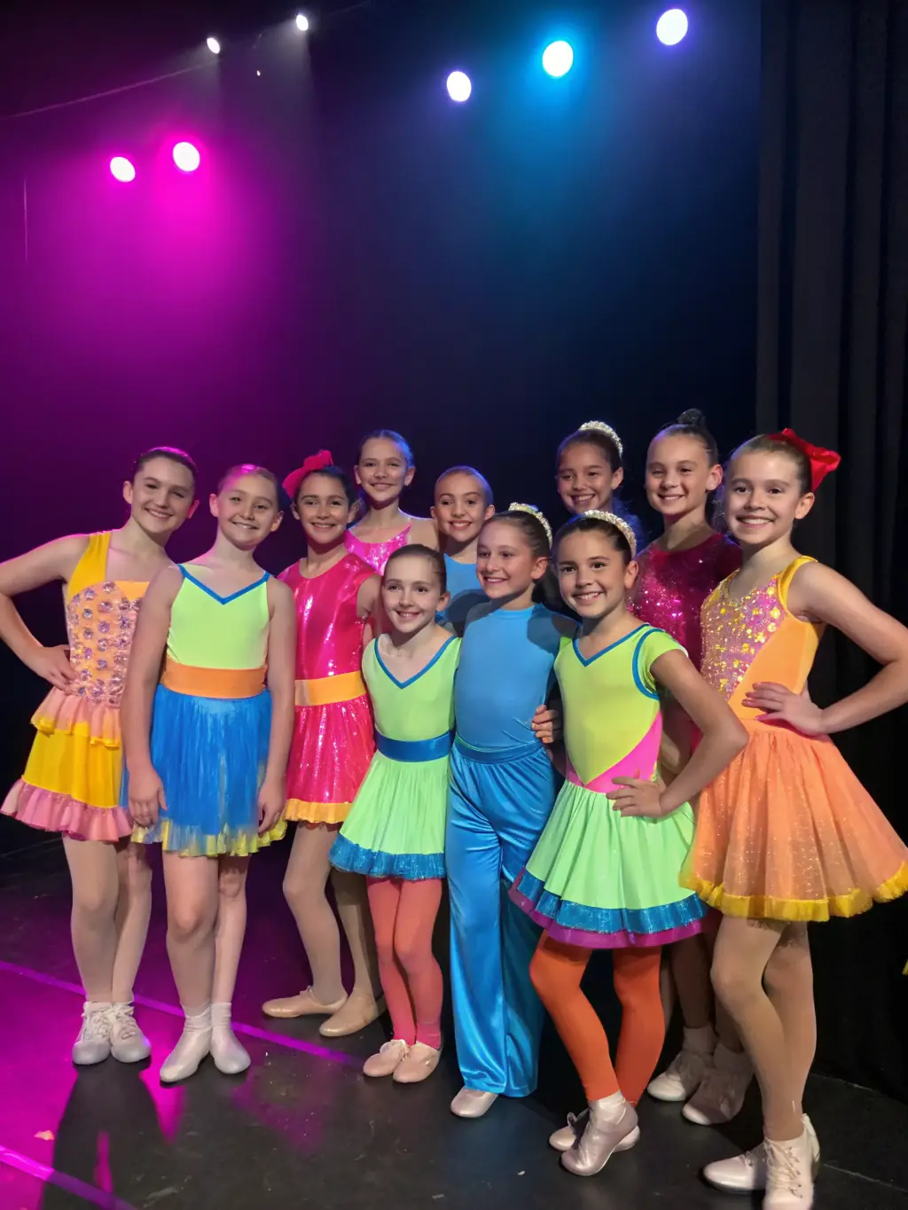 A group of children laughing and dancing together in a brightly lit studio, showcasing the joy and social interaction fostered by MOV 'N DANCE 18.